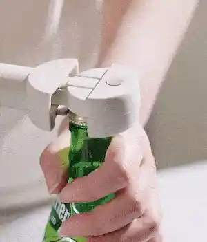 Handheld bottle and can opener in use